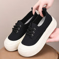 Women's camel suede platform loafers with round toe and front lace-up closure on flat rubber sole