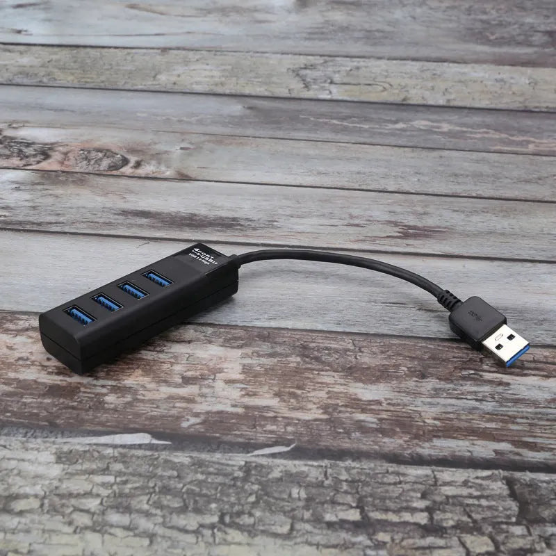 Black USB 3.0 hub with four ports, LED indicators, and a 30cm connection cable.
