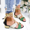 Women's beige suede sandals with a thick middle heel, front strap, and ankle strap, showing a round fish mouth toe.