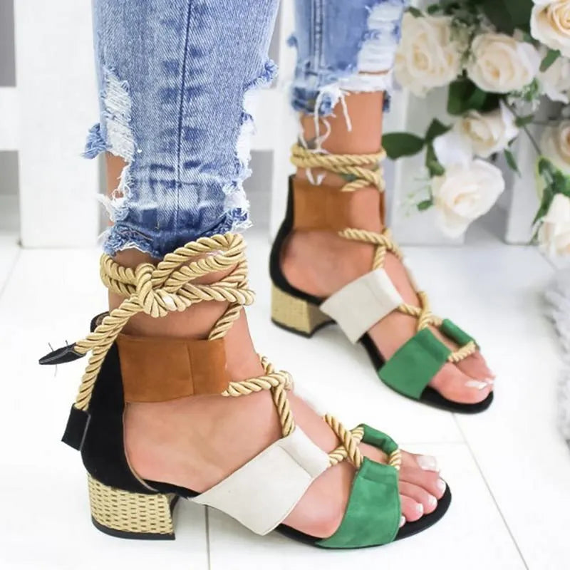 Women's beige suede sandals with a thick middle heel, front strap, and ankle strap, showing a round fish mouth toe.