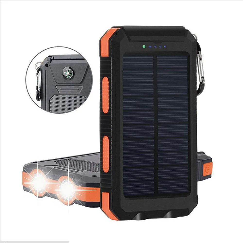 Black solar power bank showing LED flashlight, digital compass display, and solar panel on a rugged outdoor surface.