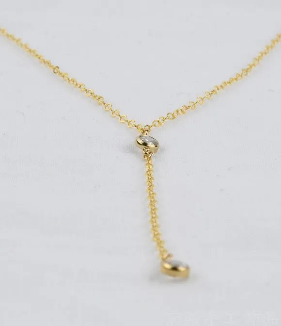 Gold colour alloy geometric pendant necklace with snake bone chain on display