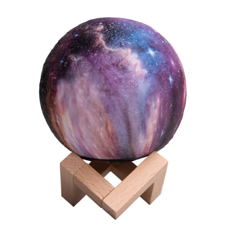 3D-printed white lunar sphere LED night light on a dark surface, showing touch and remote control.