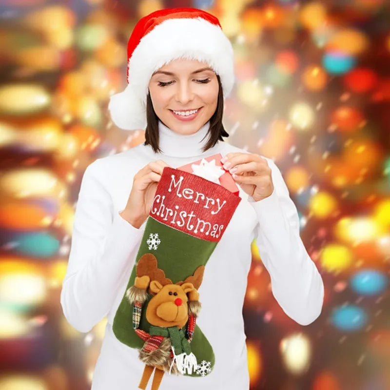 Three large Christmas stockings with 3D Santa, snowman, and reindeer designs hung on tree