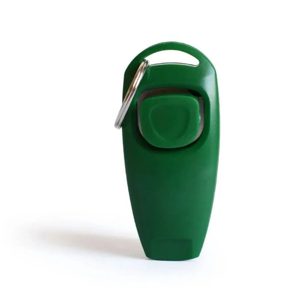 Pet training clicker and whistle set with key ring in orange, white, and blue plastic on a wooden table