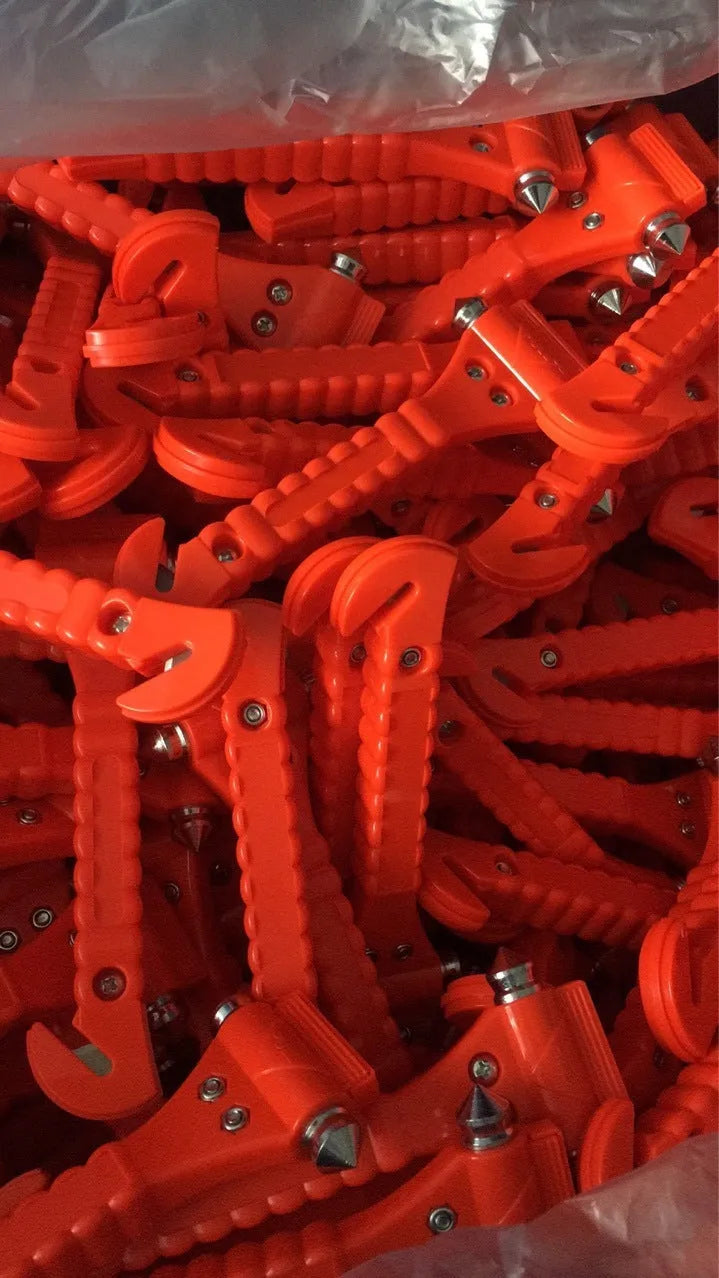 Red emergency car life-saving hammer with seatbelt cutter and spring-loaded window breaker