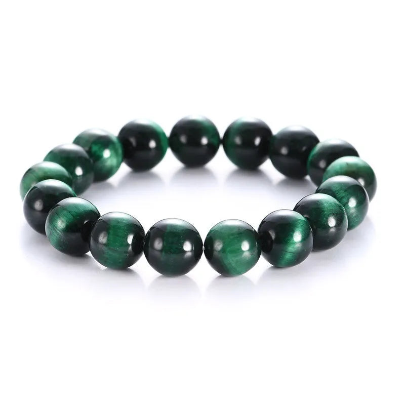 Green tiger eye stone bracelet with geometric shaped beads on a white background.