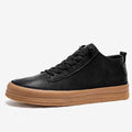 Men's black and white casual leather shoes with round toe and flat rubber sole.