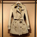 Khaki coloured women's double-breasted British-style trench coat with long flight sleeves.