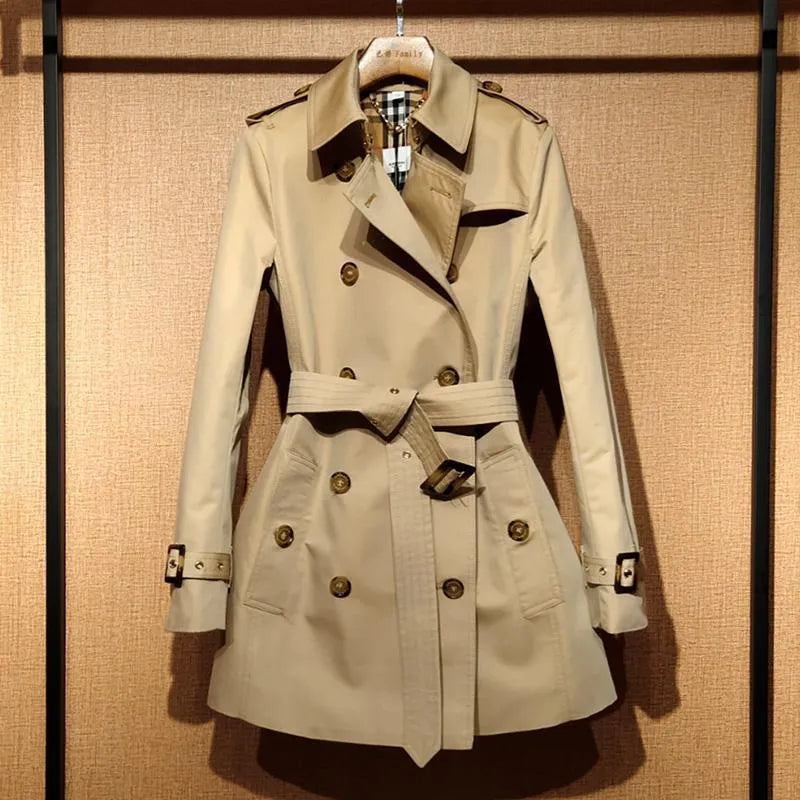 Khaki coloured women's double-breasted British-style trench coat with long flight sleeves.