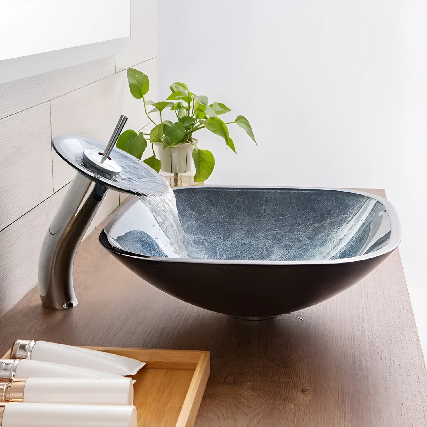 Blue grey tempered glass bathroom table basin with simple design on a vanity.