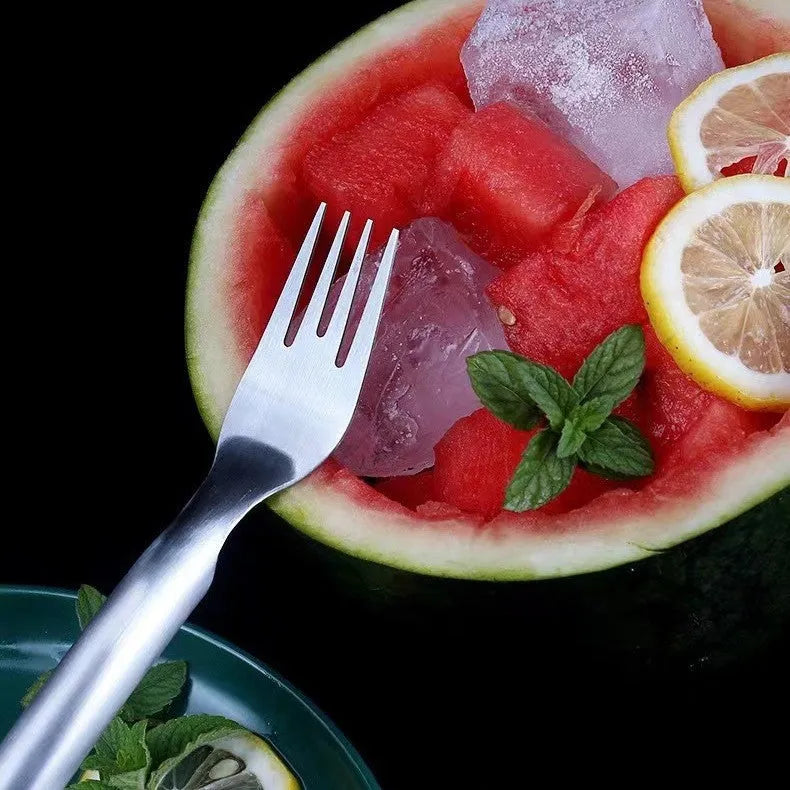Stainless steel watermelon slicer and fork tool on a kitchen surface