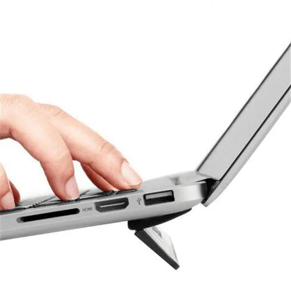 Folding notebook cooling bracket in black on a desk showing raised position for laptop heat dissipation