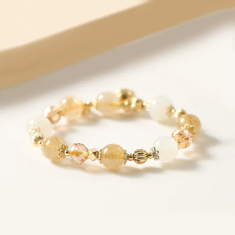 Adjustable gold tone bracelet with rutilated quartz crystal centrepiece and electroplated metal components