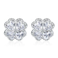 Close-up of women's white gold coloured heart shaped earrings with a four-leaf clover design, made from 925 silver and inlaid zircon stones.