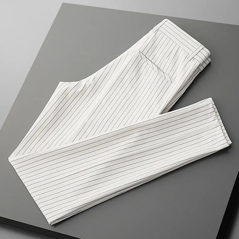 Men's loose draping suit pants in thin striped fabric showing trousers style and crop jeans cuts in black and white colours