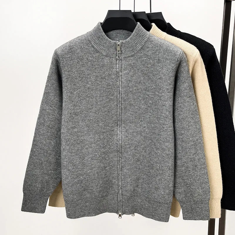 Man wearing a grey stand collar knitted cardigan with a front zipper.
