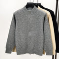 Man wearing a grey stand collar knitted cardigan with a front zipper.
