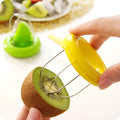 Mini kiwi fruit cutter peeler slicer on table showing compact size and stainless steel blade