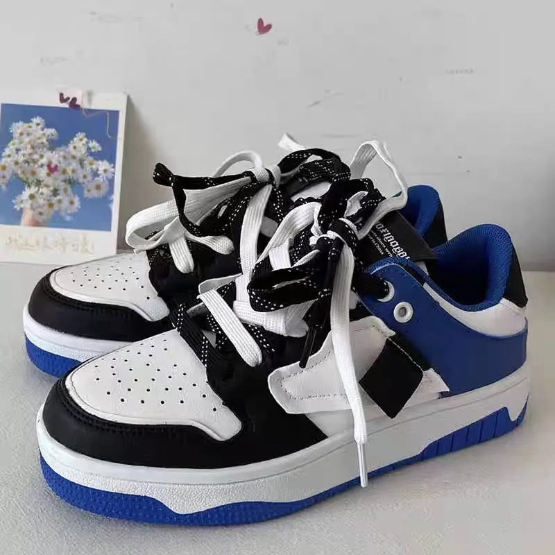 Low-top casual sneakers with synthetic leather upper, stitched detailing, and vulcanised rubber sole in white