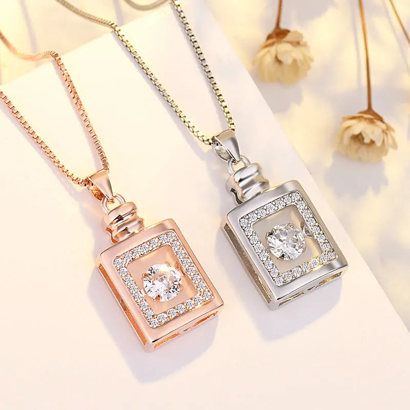 Silver tone heart pendant necklace with crown charm and bow detail on a delicate chain.