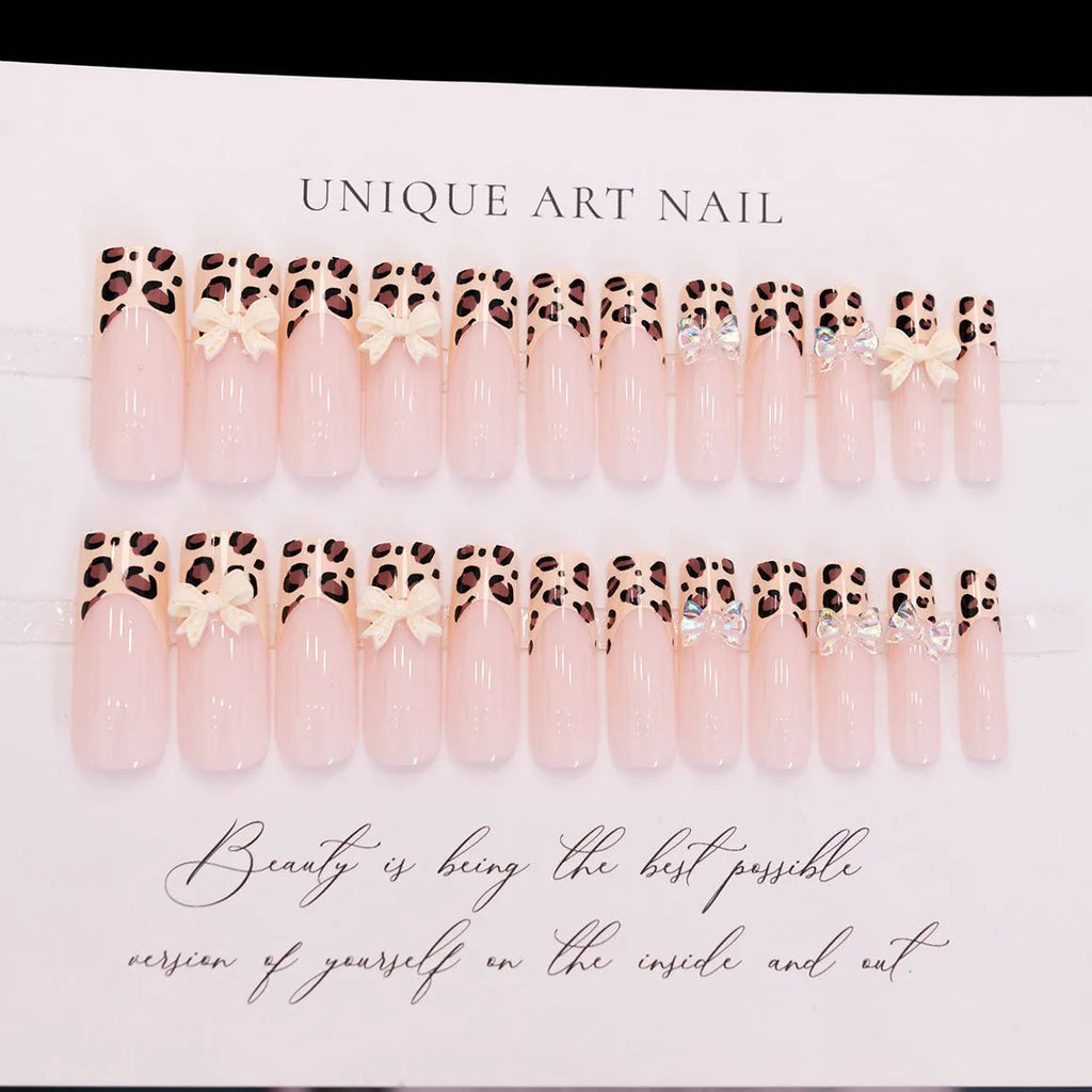 Leopard print butterfly nail art pieces on plastic backing for manicure decoration