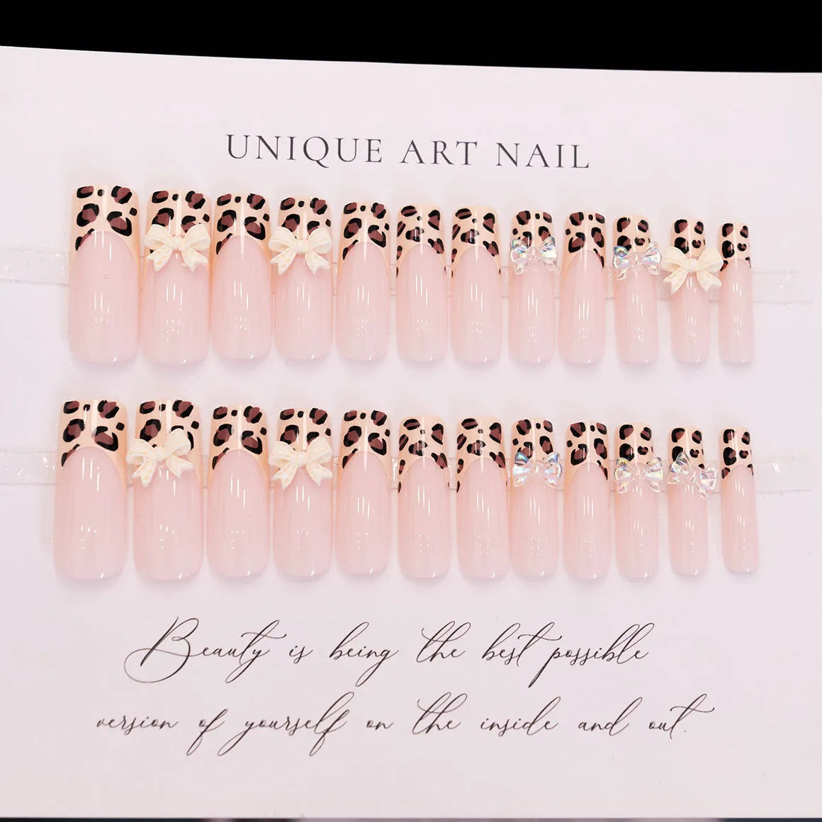 Leopard print butterfly nail art pieces on plastic backing for manicure decoration