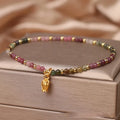 Natural tourmaline beaded anklet with flower-shaped stones on a delicate chain for women