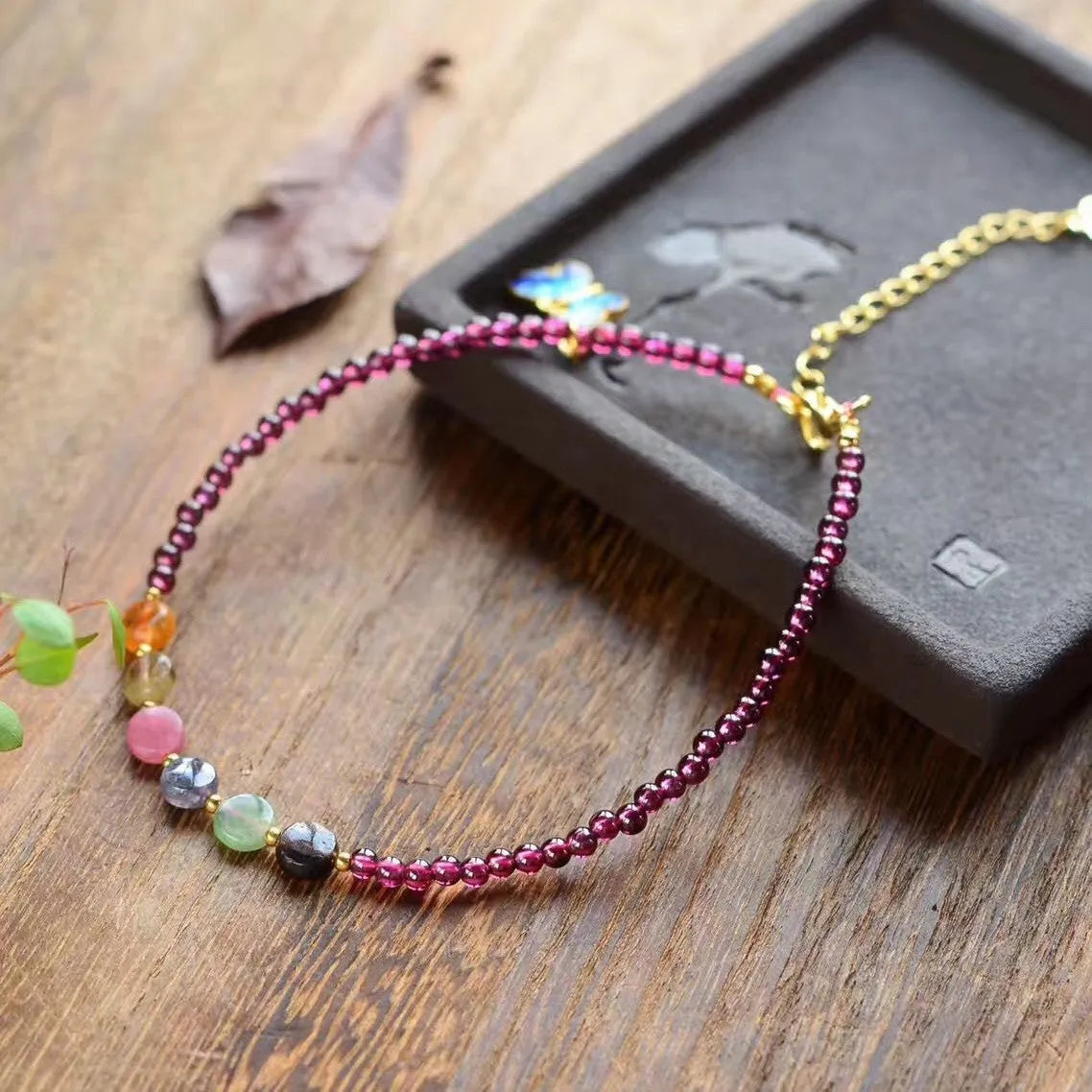Purple garnet stone bead geometric anklet on an adjustable metal chain.