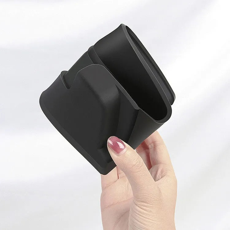 Black silicone sunglasses holder installed in Tesla centre console armrest compartment