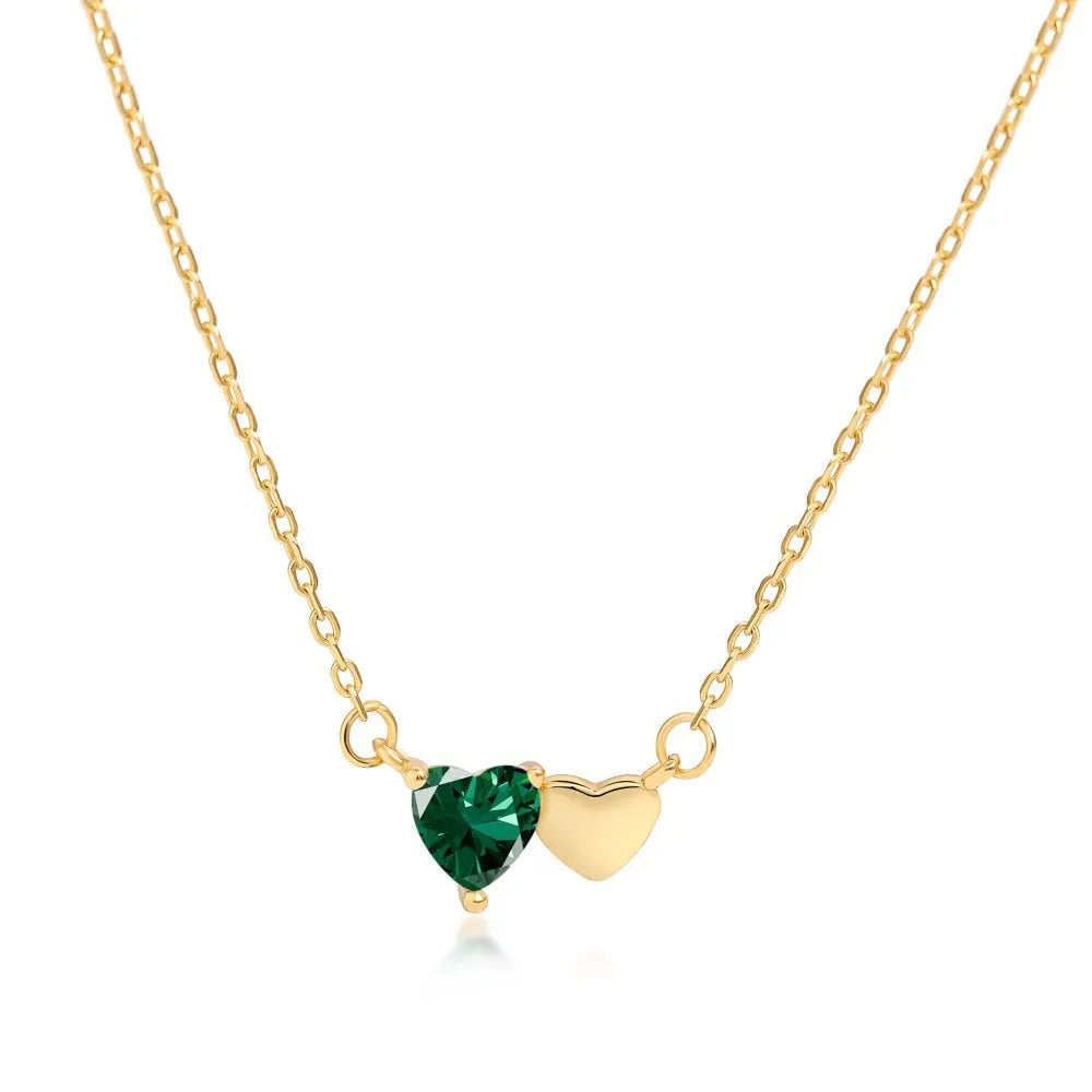 925 silver heart necklace with emerald zircon in gold finish on display