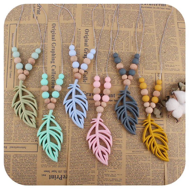 Silicone leaf teether necklace for babies over 3 months, about 35g, shown in mint green, bean green, pink, grey, turmeric, and blue
