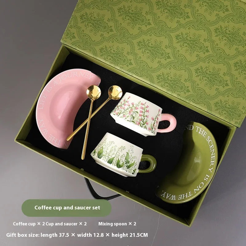 Ceramic coffee cup and saucer set for two people with stirring spoons