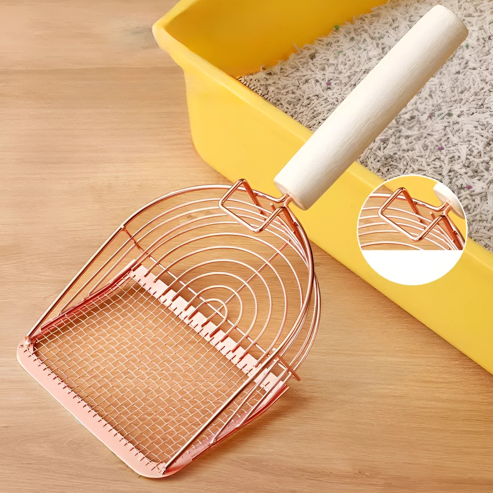 Stainless steel cat litter scoop with wooden handle showing screened design for efficient waste removal