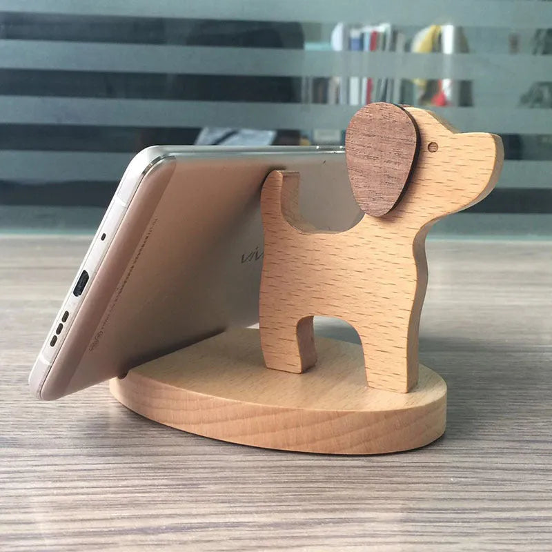 A decorative beech wood and resin mobile phone holder stand featuring themed designs like animals and zodiac signs.