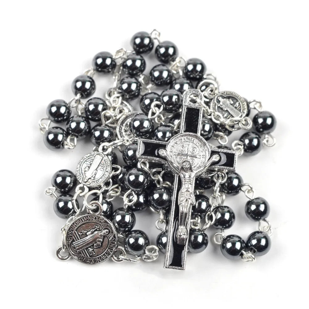 Black hematite rosary necklace with zinc alloy cross and triangle on dark background