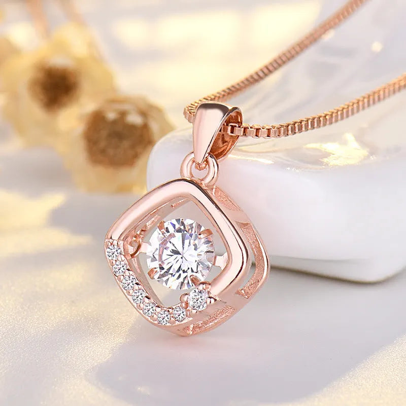 Silver tone heart pendant necklace with crown charm and bow detail on a delicate chain.