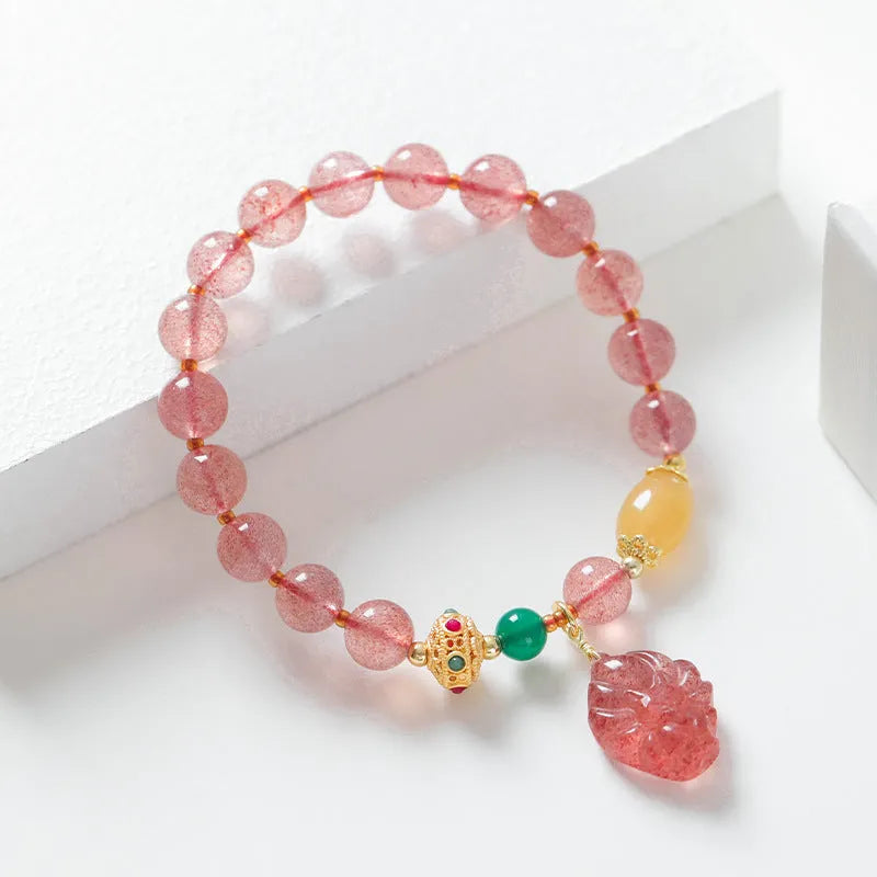 Women's crystal bracelet with nine tail fox design in polished natural strawberry quartz beads