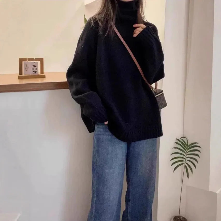 Women's loose grey turtleneck sweater with thick textured pile collar, casual style.