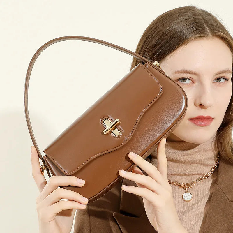 Genuine leather baguette handbag in horizontal square clamshell design, shown in black colour