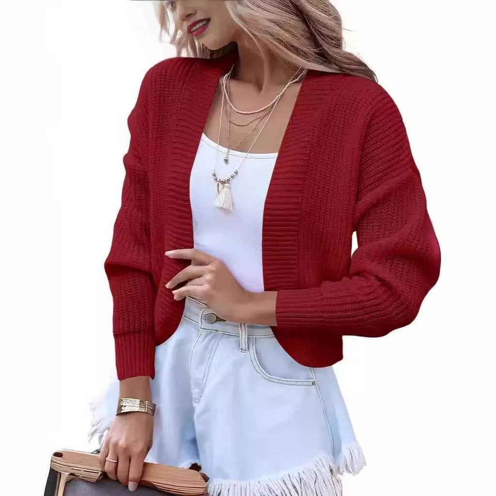 Women's short cape knitted cardigan sweater in solid colour, long sleeves, open front, polyester knit fabric.