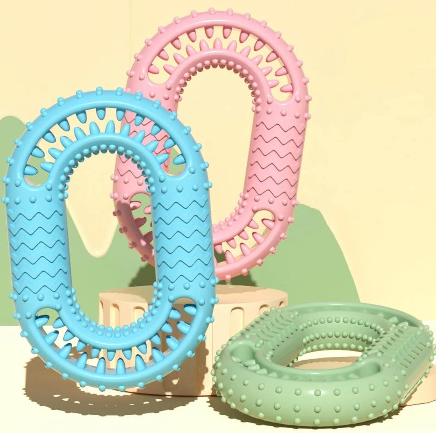 Blue, green, and pink heavy-duty O-ring shaped dog chew toy for aggressive chewers.