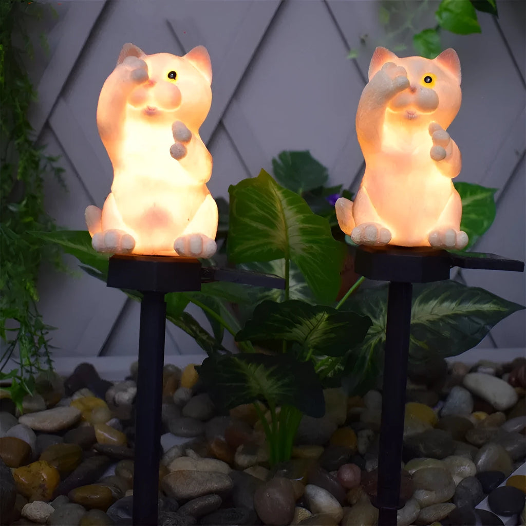 Brown cat-shaped resin solar light standing in a garden