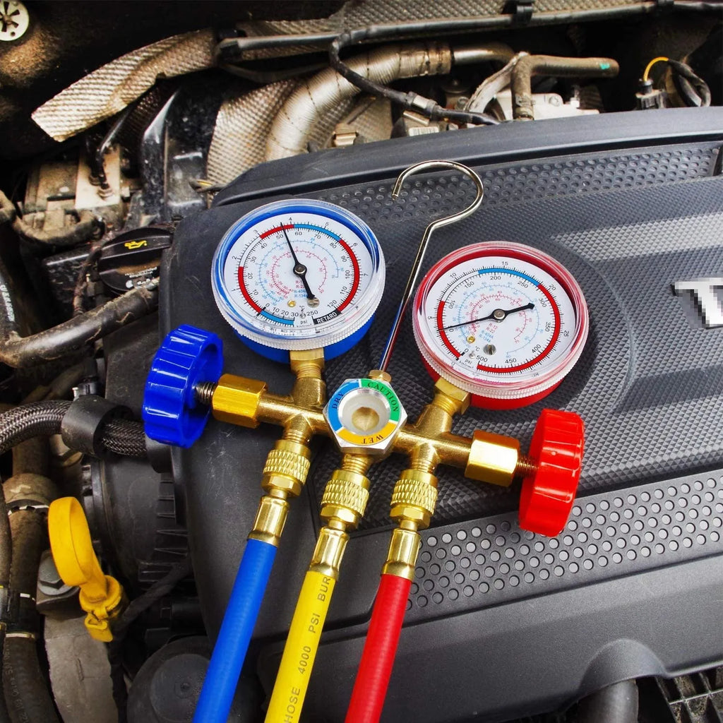 Refrigerant instrument cluster with yellow and red colour-coded hoses, brass manifold, and hook for automotive AC service