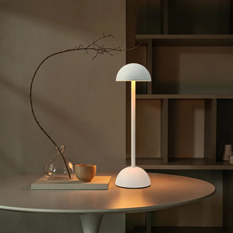 Metal mushroom table lamp in high foot design with white finish on a bar table