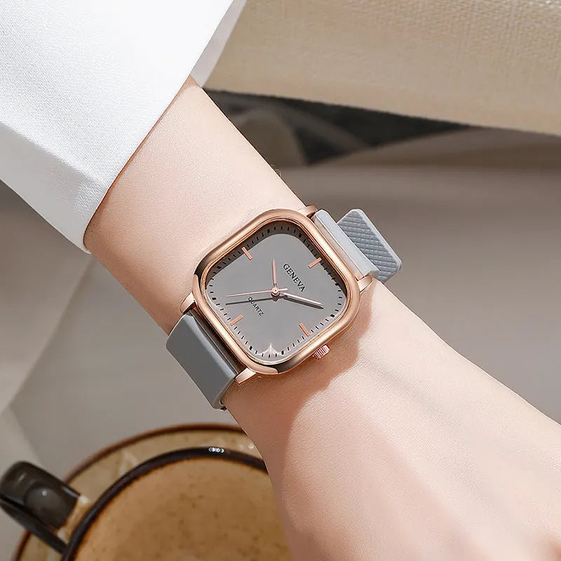 Women's rose gold square dial quartz watch with plastic strap on white background