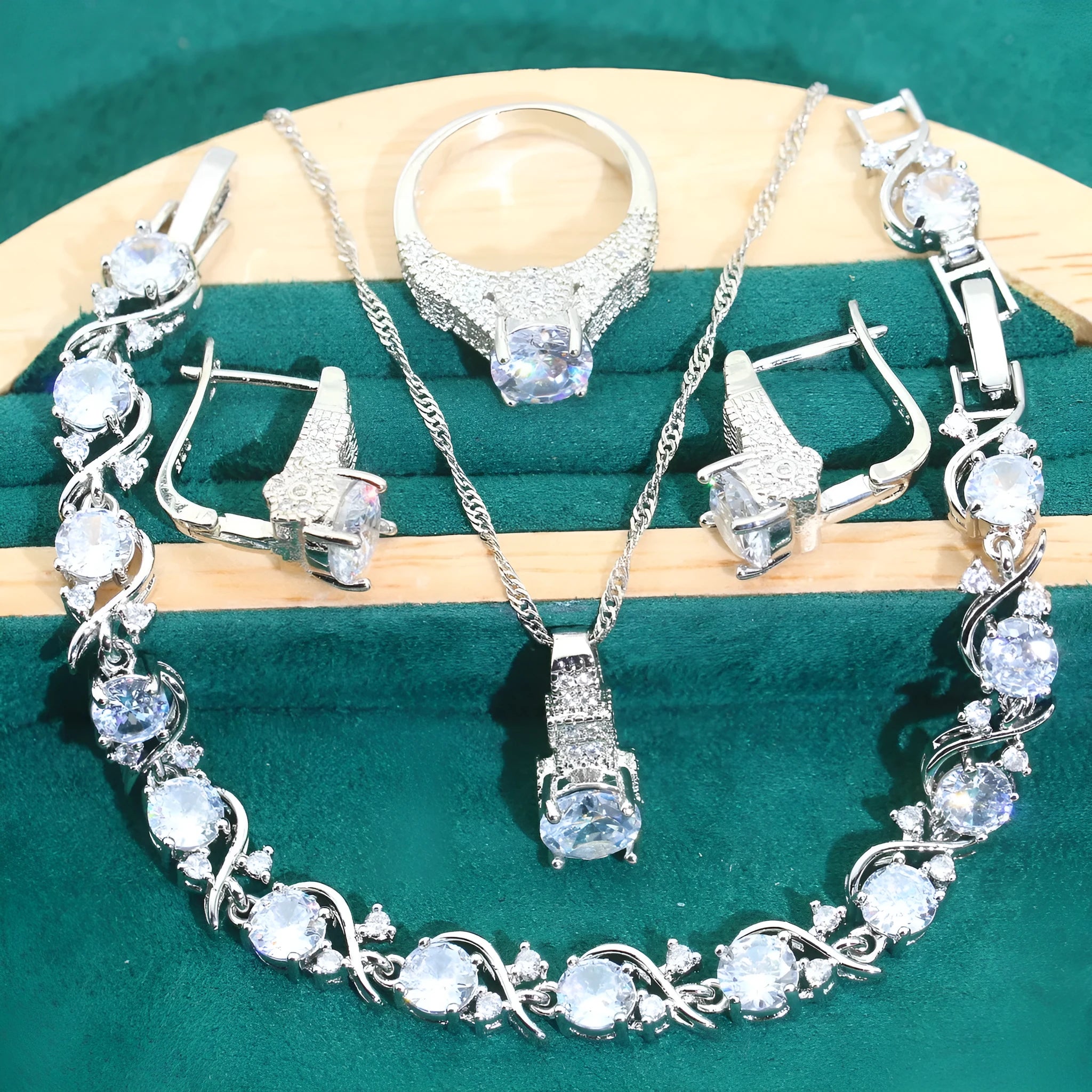 Four-piece bridal jewellery set with zircon details, water wave chains, and alloy pendants in presentation