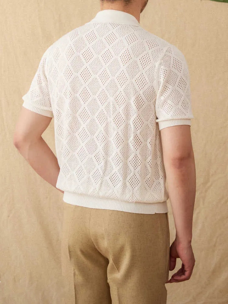 Light brown short sleeve cotton cardigan with a front zipper and lapel collar laid flat.