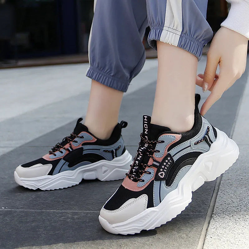 Women's thick-soled casual sports shoes with mesh upper and buckle detailing in black colour