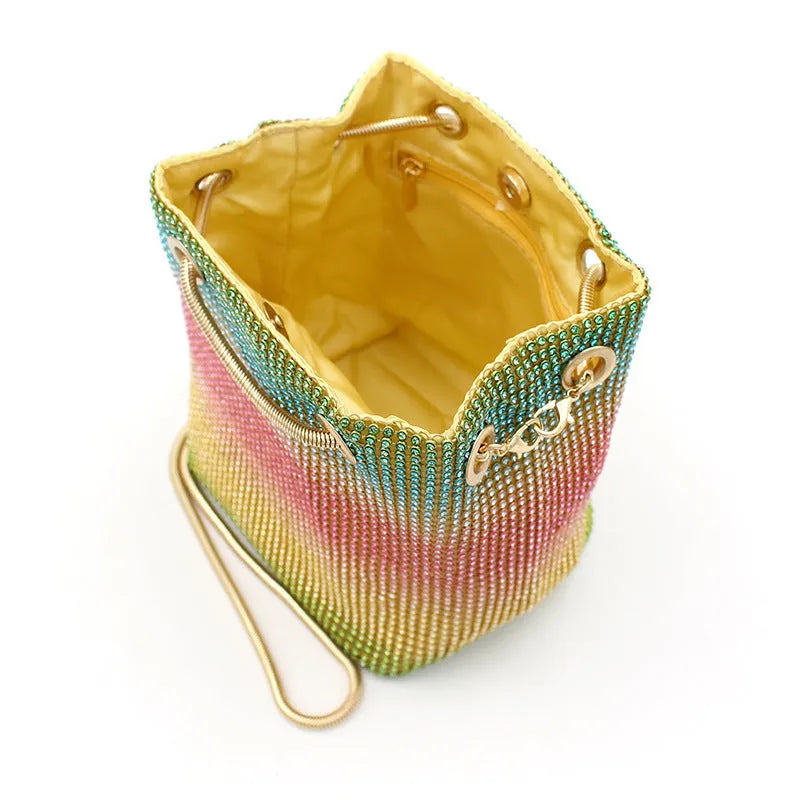Colourful rainbow rhinestone bucket bag with a single shoulder strap.